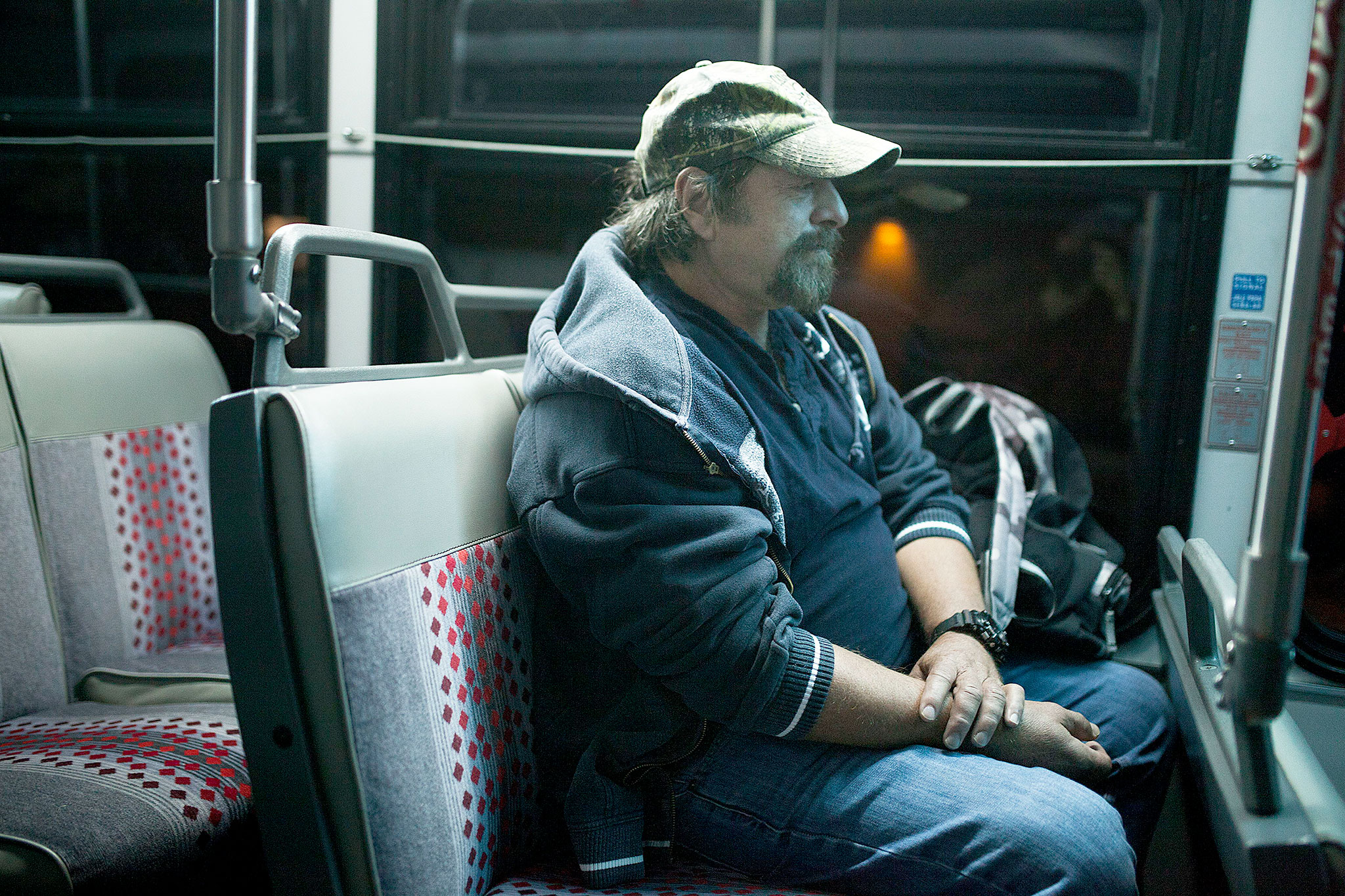 Gene Martin rides the bus before sunrise to an Alcoholics Anonymous meeting in Everett. (Ian Terry / The Herald)
