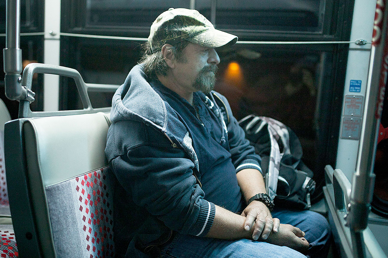 Gene Martin rides the bus before sunrise to an Alcoholics Anonymous meeting in Everett. (Ian Terry / The Herald)