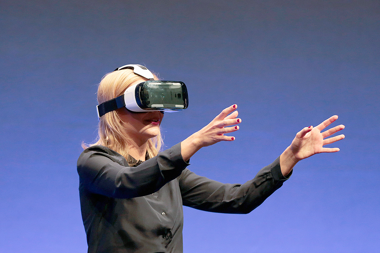 British television presenter Rachel Riley shows a virtual-reality headset called Gear VR in 2014. (AP Photo/Markus Schreiber)
