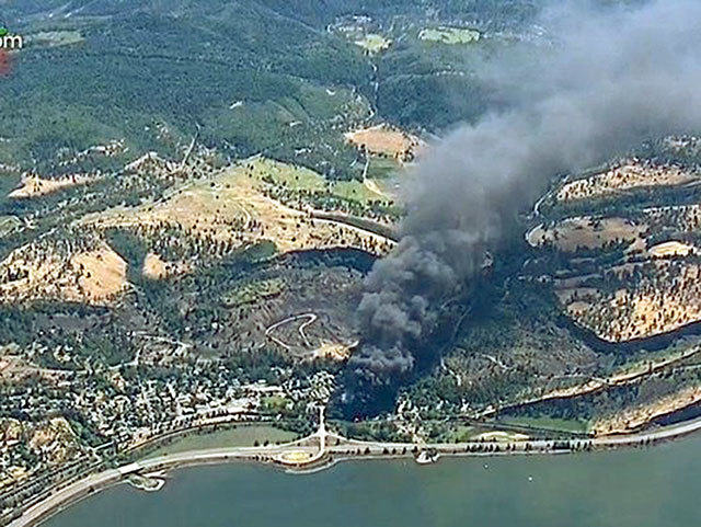 In this June 3 image from video, smoke billows from a Union Pacific train that derailed near Mosier, Oregon, in the scenic Columbia River Gorge. Federal investigators on Thursday blamed Union Pacific Railroad for the derailment along the Oregon-Washington border, saying the company failed to properly maintain its track. (KGW-TV, file)