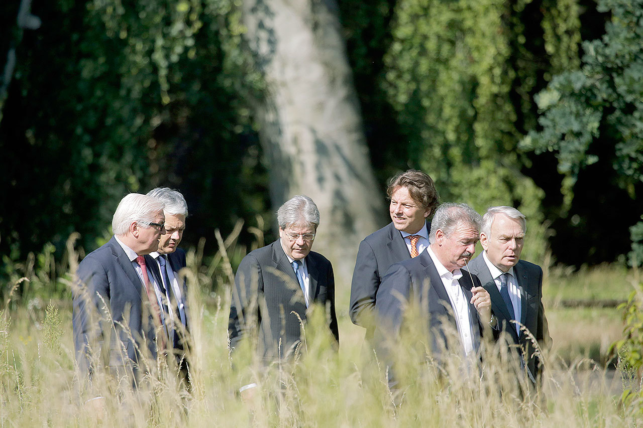 The Foreign Ministers from EU’s founding six — from left, Frank-Walter Steinmeier from Germany, Didier Reynders from Belgium, Paolo Gentiloni from Italy, Bert Koenders from the Netherlands, Jean Asselborn from Luxemburg and Jean-Marc Ayrault from France — walk through the park of the Foreign Ministry’s guest house Villa Borsig during a meeting to talk about Brexit in Berlin on Saturday. (AP Photo/Markus Schreiber)