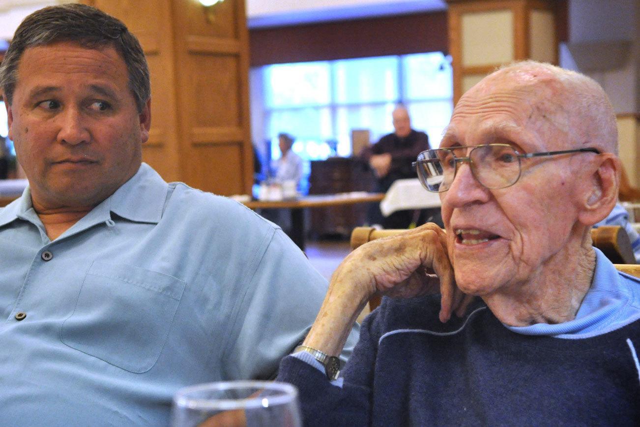 Clyde Christensen, left, of Miami, visits with his 92-year-old father, Richard Christensen, in the dining hall of his senior-living home in Fresno, California. (Sue Misao / The Herald)