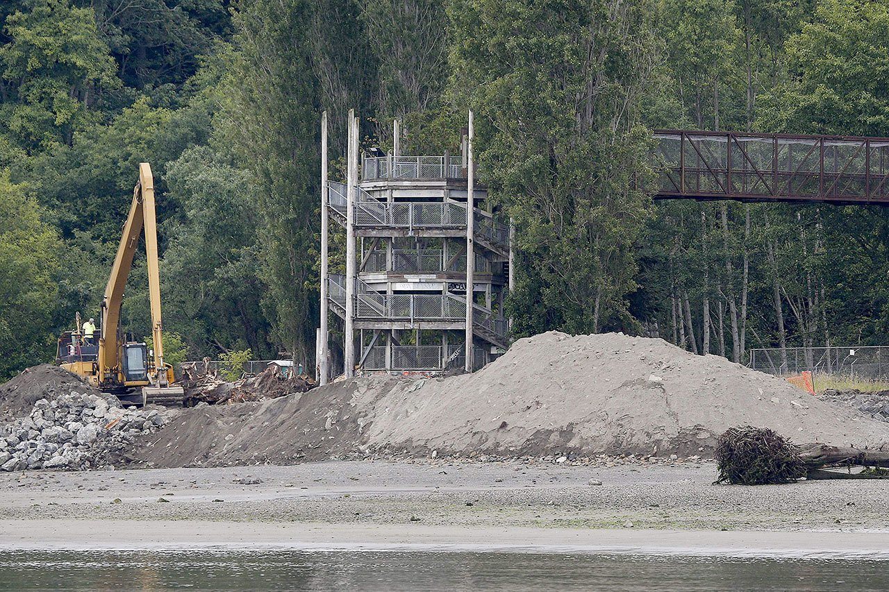 The pedestrian bridge at Howarth Park in Everett is seen as an excavator works Tuesday. (Ian Terry / The Herald)