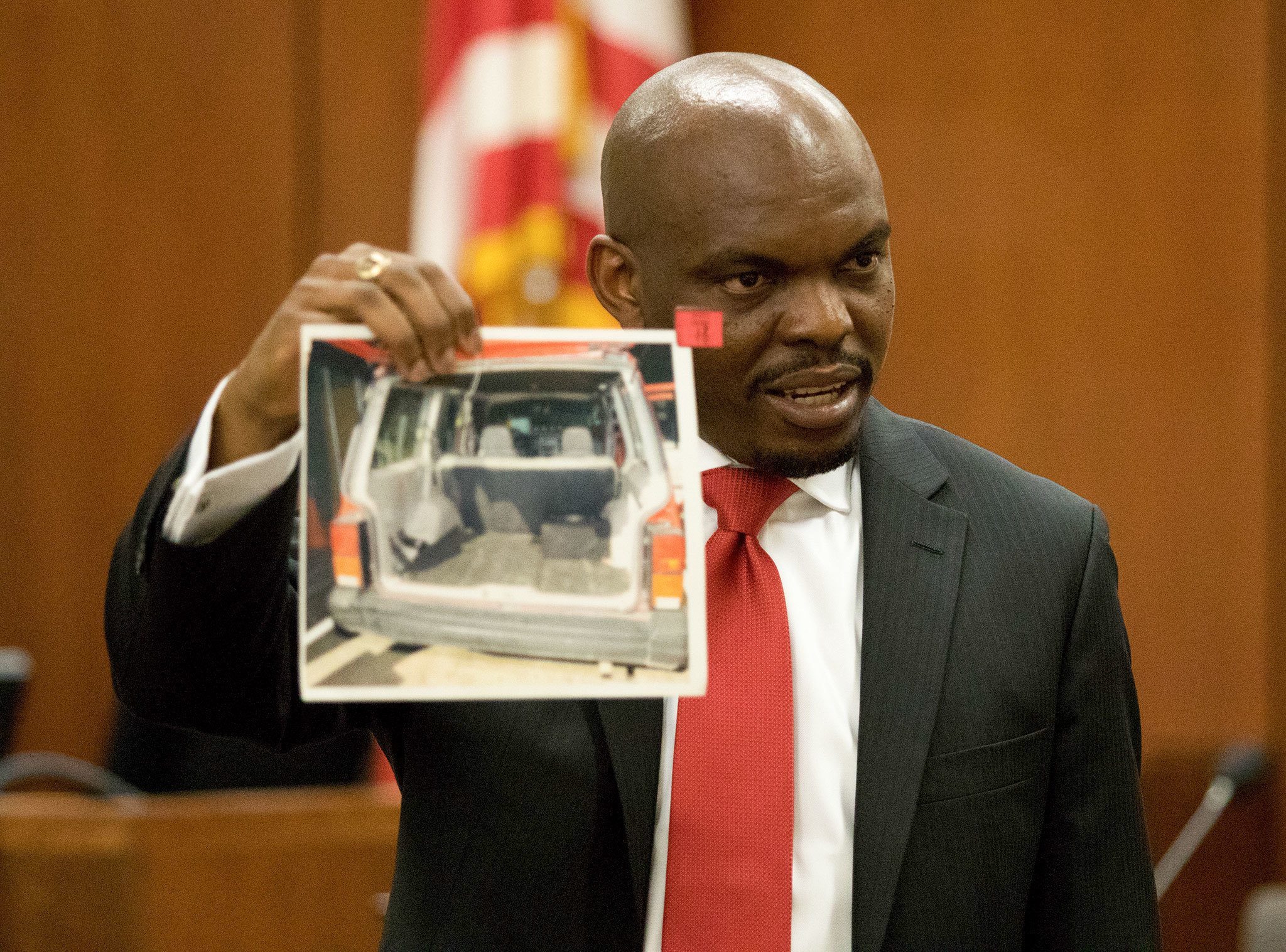 Snohomish County Deputy Prosecutor Edirin Okoloko shows a photo of the car involved in the 2002 Rachel Burkheimer murder during closing statements in the trial of John Whitaker for Burkheimer’s 2002 murder. (Andy Bronson / The Herald)