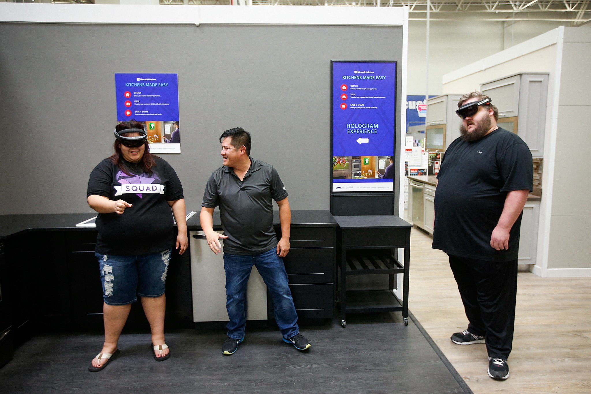 Lowe’s employee Tin Tran (center) helps customers Kim Correa (left), of Bothell, and Danny Baranowsky with their Microsoft Hololens virtual reality glasses used to visualize a custom kitchen at the store’s Lynnwood location on Tuesday, June 7. With the glasses, customers can mix and match various kitchen appliances and see what they’d look like in real time to scale. (Ian Terry / The Herald)