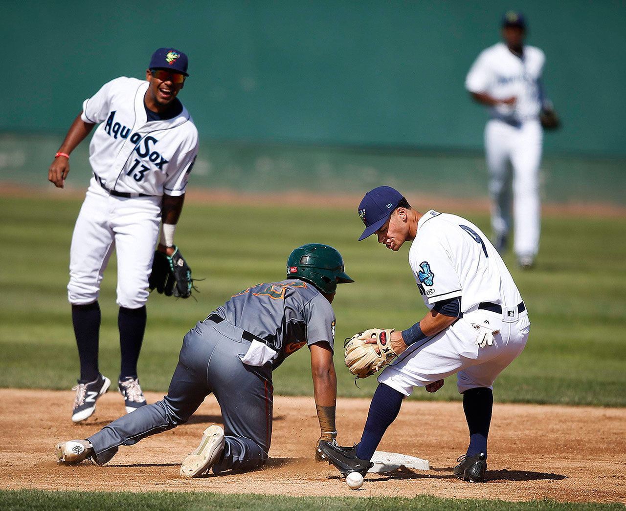 AquaSox shortstop Bryson Brigman (9) looks for the ball as Boise’s Luis Castro slides safely back into second base on a pickoff play during Sunday’s game at Everett Memorial Stadium. (Ian Terry / The Herald)