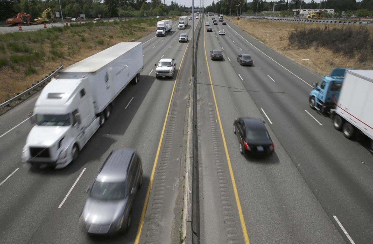 Cars and trucks move along I-5 on June 1 in Lakewood. Traffic is expected to be plentiful throughout the state over the Fourth of July weekend. (Ted S. Warren / Associated Press)