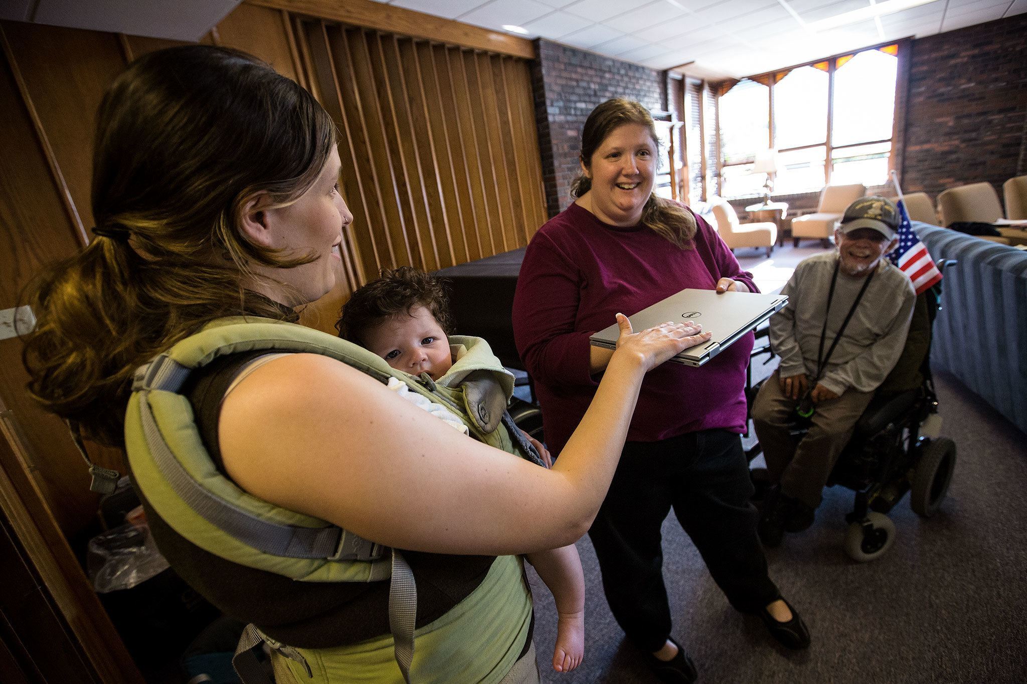 Daniella Beccaria / For the Herald Pastor Rebecca Sumner blesses Grace Hutson-Miller’s laptop at “blessing of the electronics” during a church service for Our Common Table on Sunday, Jun. 26, 2016 at the First Presbyterian Church in Everett. Sumner organized the event to help members focus on how electronics influence their lives. “Everything we have in our life can be used for good and can be used for harm,” she said. “It is important to remember that what we have is blessed.”