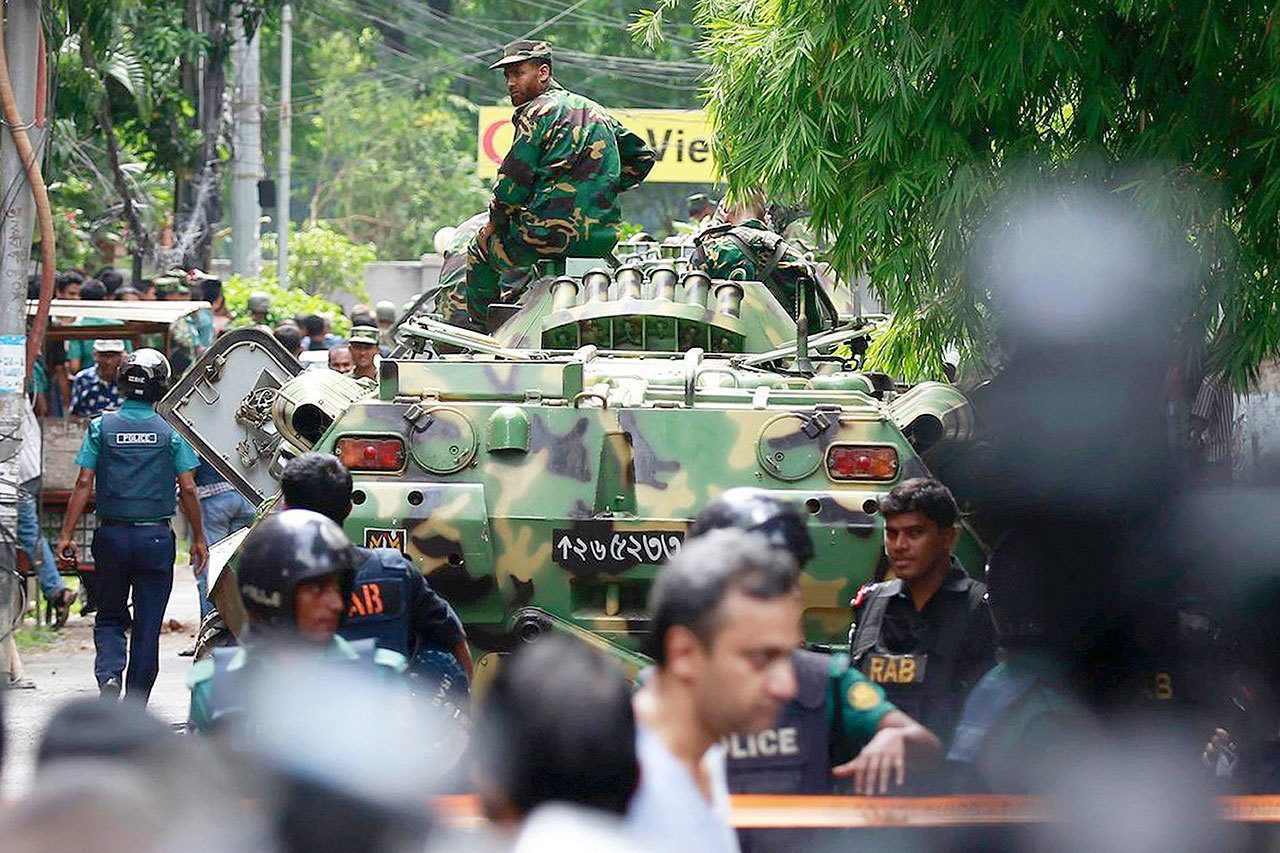 Bangladeshi soldiers and security personnel cordon off an area after heavily armed militants took dozens of hostages in a diplomatic zone of the Bangladeshi capital of Dhaka on Saturday. (AP Photo)