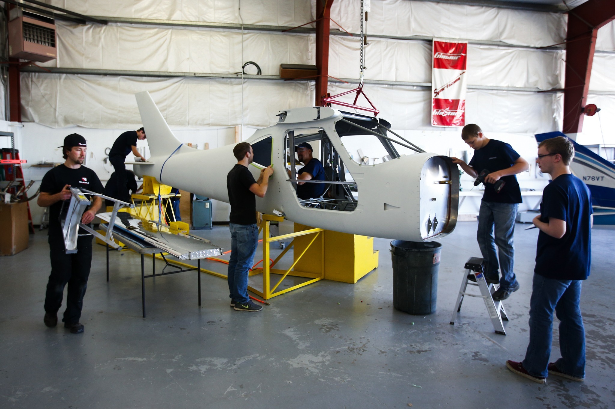 Students from Weyauwega-Fremont High School in Wisconsin work together with Glasair Aviation employees to build a Sportsman aircraft at the company’s manufacturing facility in Arlington on June 22. Four students were selected to spend two weeks working with and learning from professional mechanics at Glasair as part of the General Aviation Manufacturers Association’s Aviation Design Challenge. (Ian Terry / The Herald)