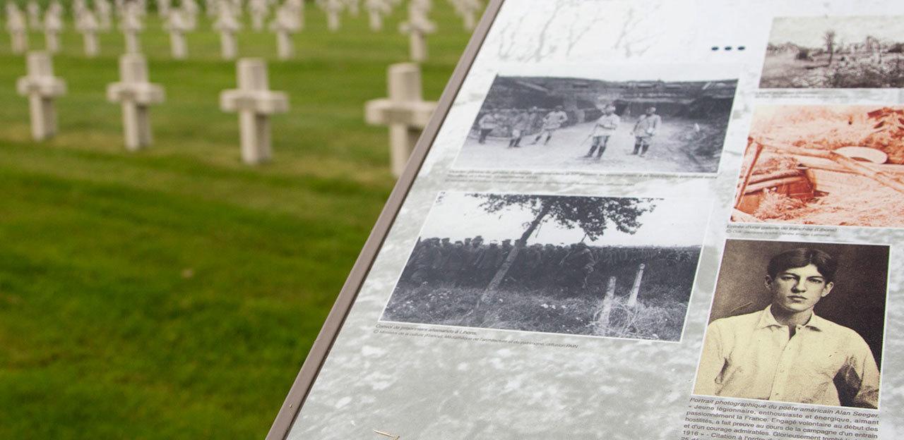 An information board with a photograph of Alan Seeger guides visitors through the French National Necropolis of Lihons, in Lihons, France, on June 8. (AP Photo / Virginia Mayo)
