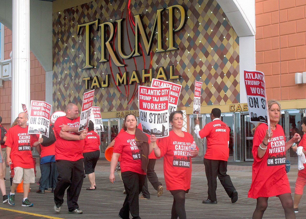 Striking union members walk a picket line outside the Trump Taj Mahal casino in Atlantic City, New Jersey, on Friday. Local 54 of the Unite-HERE union went on strike against the casino, which is owned by billionaire investor Carl Icahn. (AP Photo / Wayne Parry)
