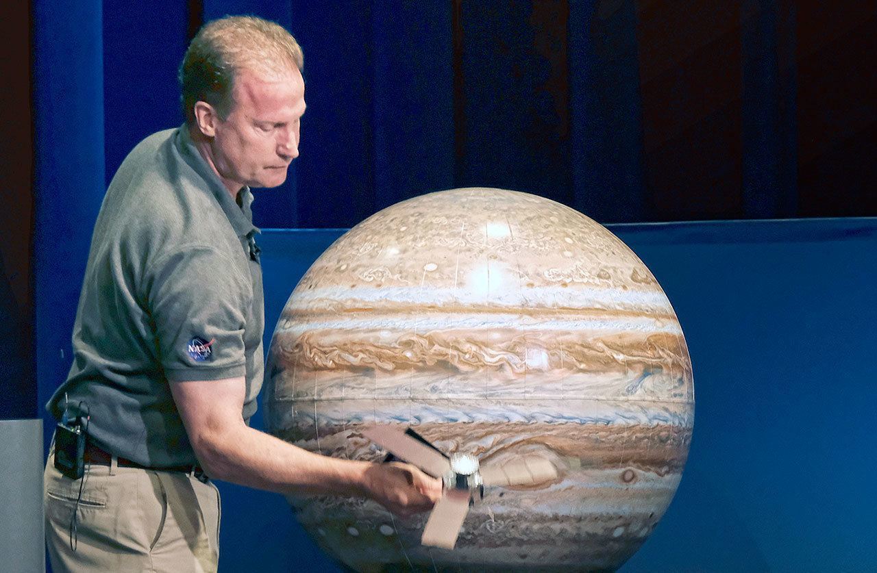 Rick Nybakken, Juno Project Manager, holds a model of the Juno spacecraft discusses the orbit the Juno spacecraft will take around Jupiter during a briefing at the Jet Propulsion Laboratory in Pasadena on Monday. (AP Photo/Richard Vogel)