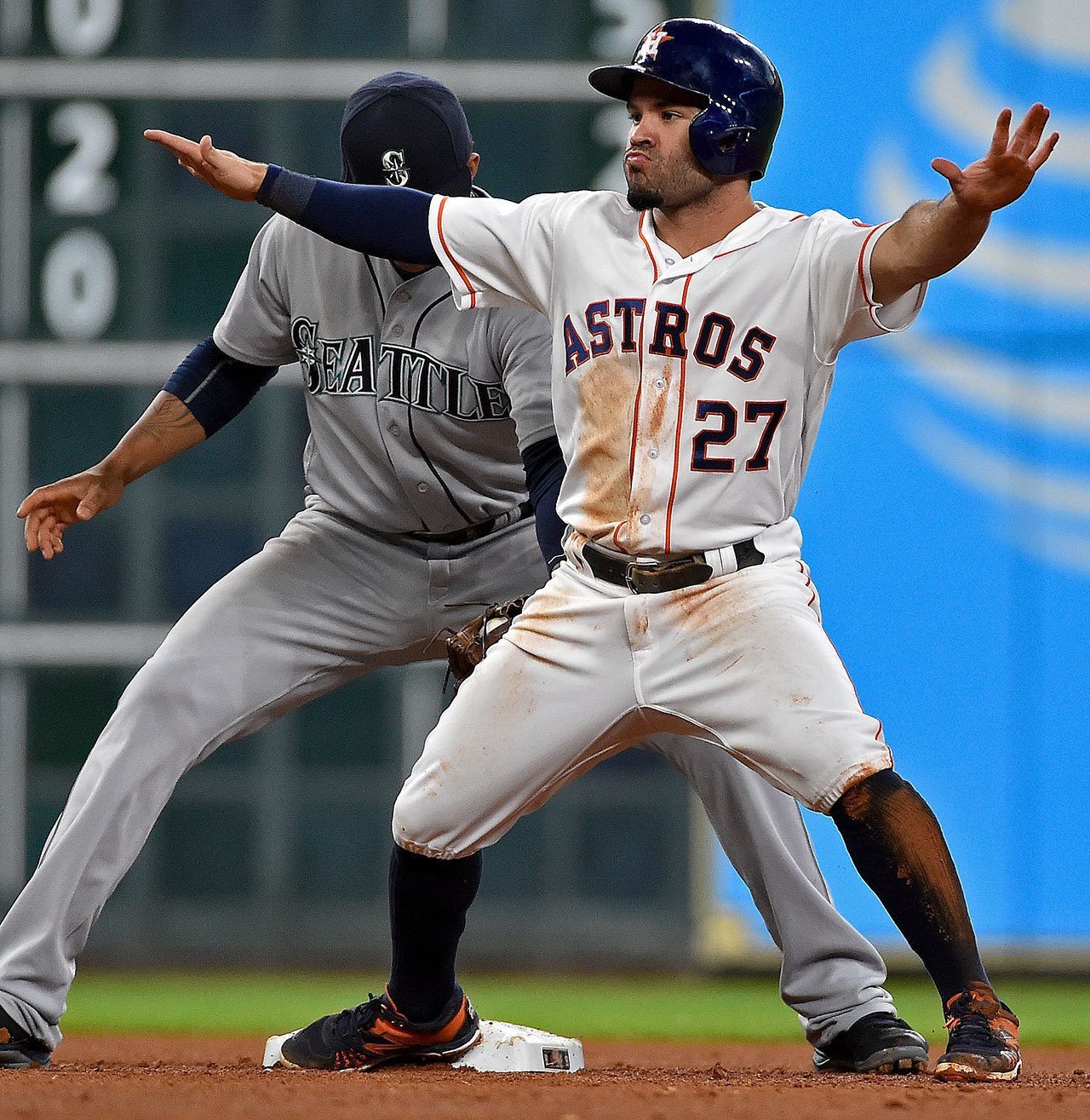 The Astros’ Jose Altuve (27) signals himself safe after stealing second base past Mariners shortstop Ketel Marte (left) in the fourth inning of a game Tuesday in Houston. (AP Photo/Eric Christian Smith)