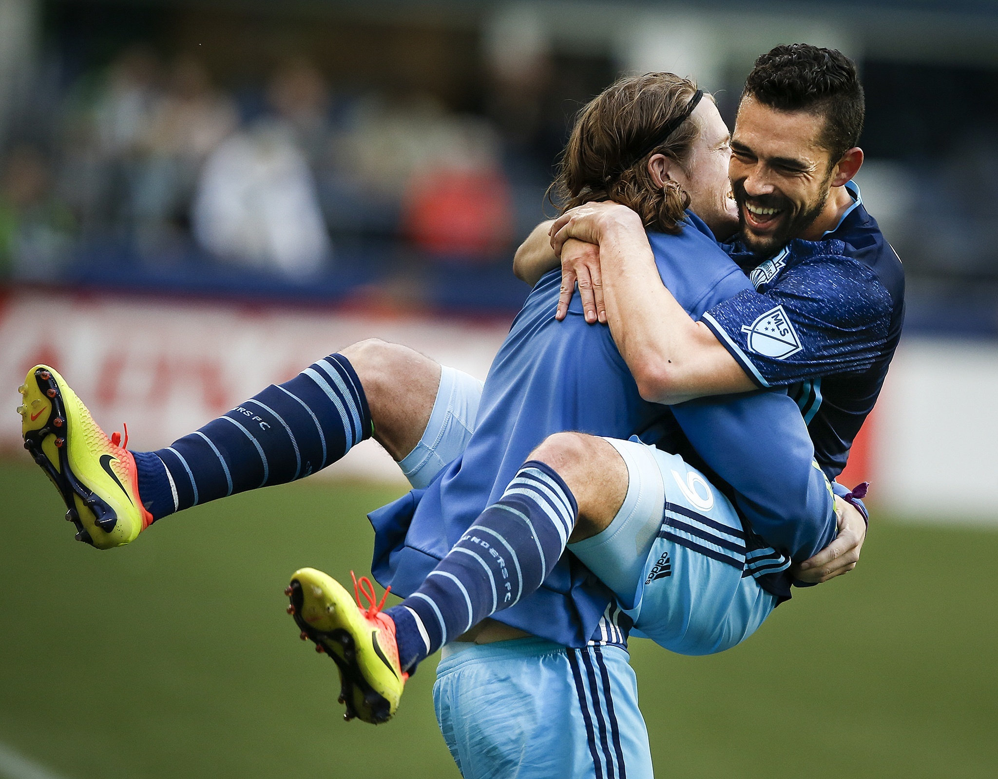 Sounders forward Herculez Gomez (right) leaps into the arms of teammate Erik Friberg after scoring on a penalty kick during an international friendly match against West Ham United at CenturyLink Field in Seattle on Tuesday. (Ian Terry / The Herald)