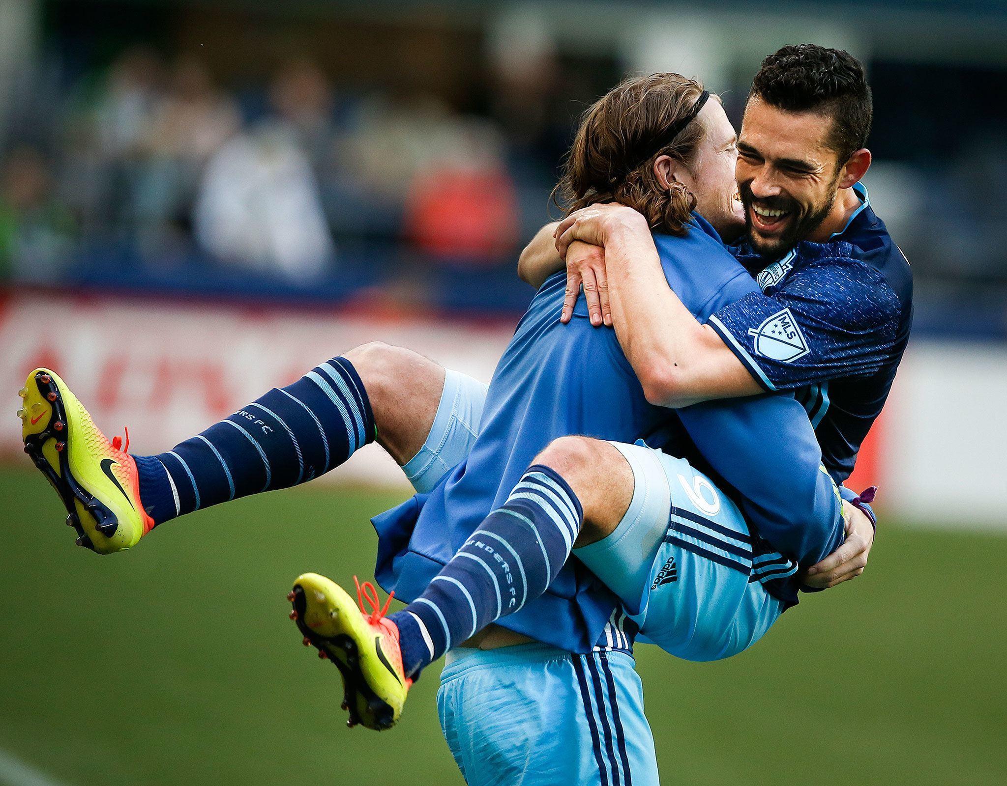 Sounders forward Herculez Gomez (right) leaps into the arms of teammate Erik Friberg after scoring on a penalty kick during aninternational friendly against West Ham United on Tuesday at CenturyLink Field in Seattle. The Sounders won 3-0. (Ian Terry / The Herald)
