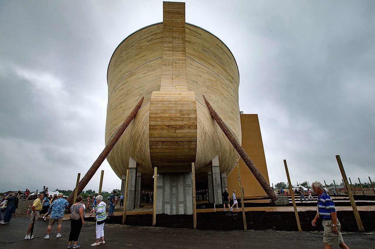 Visitors roam around a replica Noah’s Ark as rain clouds pass overhead at the Ark Encounter theme park during a media preview day Tuesday in Williamstown, Kentucky. (John Minchillo / Associated Press)