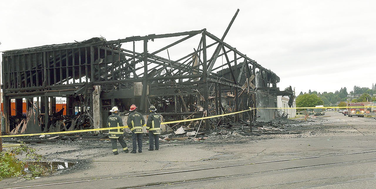 A massive fire that burned through a city block in downtown Olympia destroyed a 100-year-old warehouse in the 200 block of Adams Street in Olympia on Tuesday. Fire crews from Olympia, Lacey and McLane Fire Departments responded. No injuries were reported. (Steve Bloom / The Olympian, via AP)