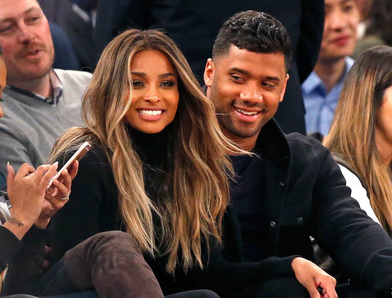 In this Feb. 9, 2016 file photo, singer Ciara (second from left) and Seattle Seahawks quarterback Russell Wilson sit courtside while attending an NBA game between the New York Knicks and the Washington Wizards in New York. The couple were married Wednesday at Peckforton Castle in Cheshire, England. (AP Photo/Kathy Willens)