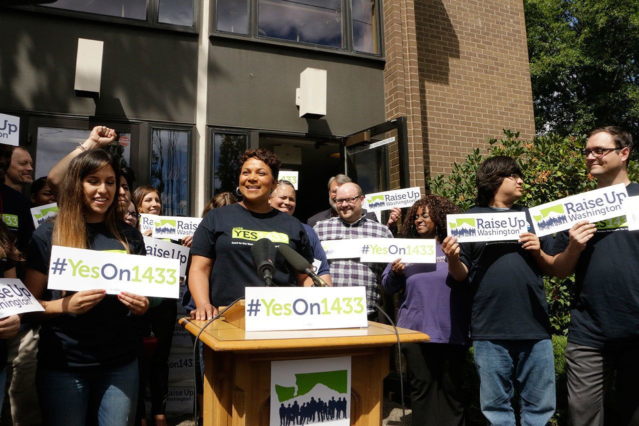 Supporters gather to talk to the media before turning in signed petitions in support of a ballot measure to raise Washington state’s minimum wage on Wednesday in Olympia. Initiative 1433 seeks to incrementally increase the state’s rate over the next four years to $13.50 an hour and to provide paid sick leave to employees who don’t currently have it. (AP Photo/Rachel La Corte)