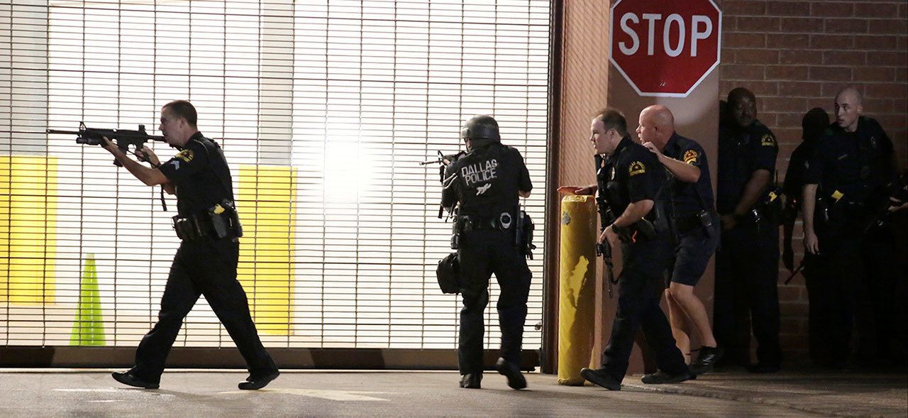 Dallas police respond after shots were fired during a protest over recent fatal shootings by police in Louisiana and Minnesota, on Thursday. Snipers opened fire on police officers during protests; several officers were killed, police said. (Maria R. Olivas/The Dallas Morning News via AP)
