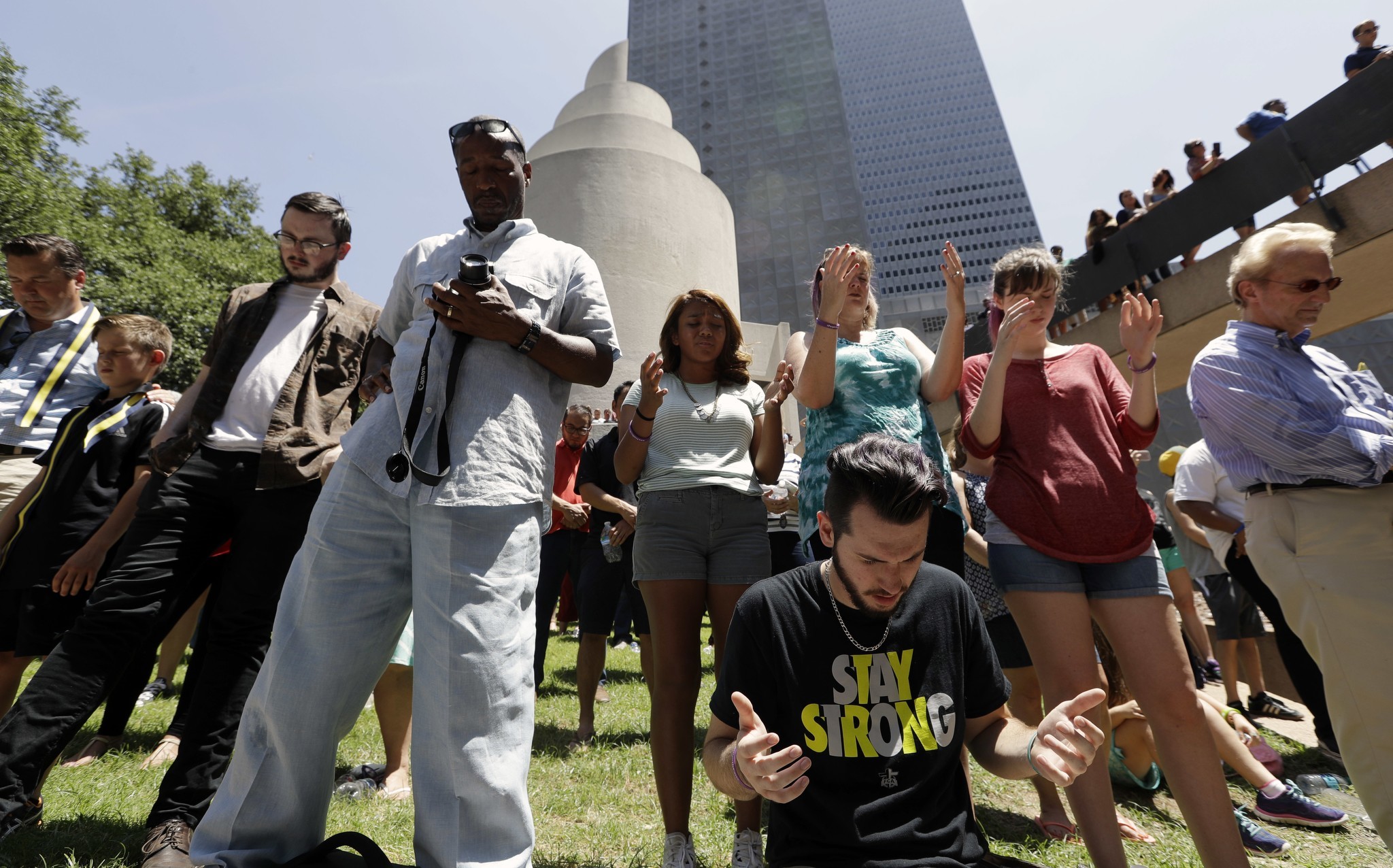People take part in a prayer vigil at Thanksgiving Square on Friday in Dallas. (AP Photo/Eric Gay)