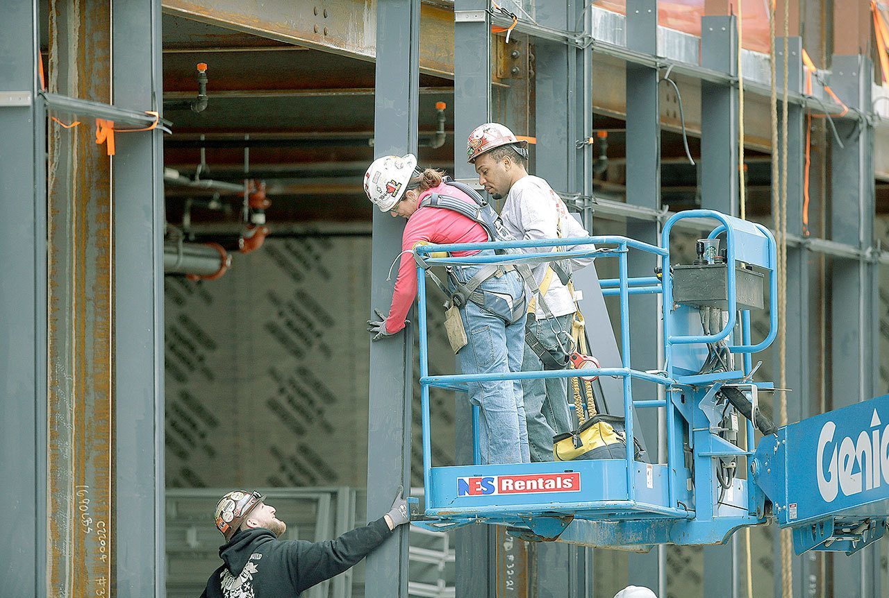 Workers construct a building in Boston in May. (AP Photo/Steven Senne)