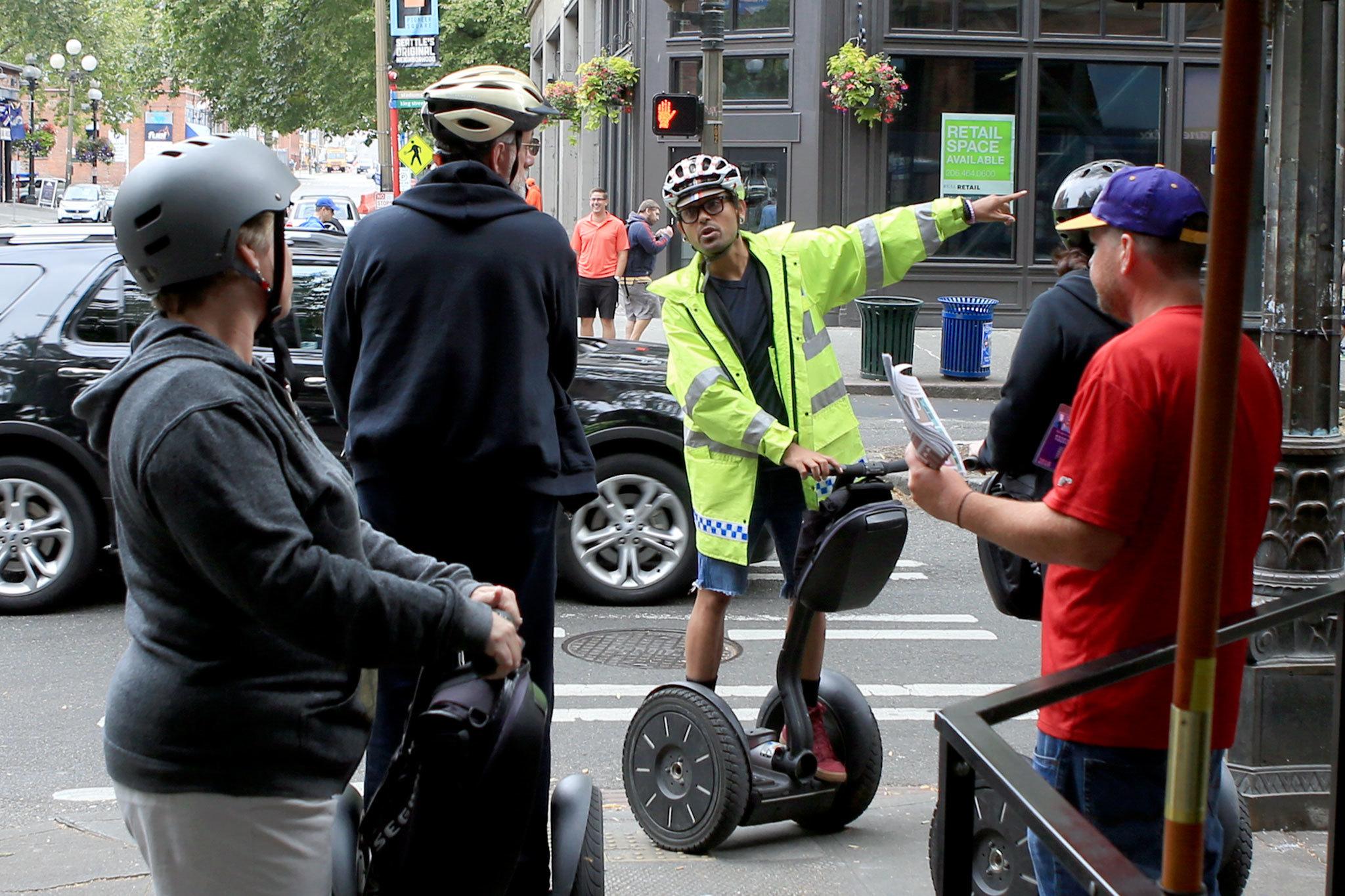 Jonathan Martinez leads a Segway tour through downtown Seattle and Seattle Center. (Kevin Clark / The Herald)