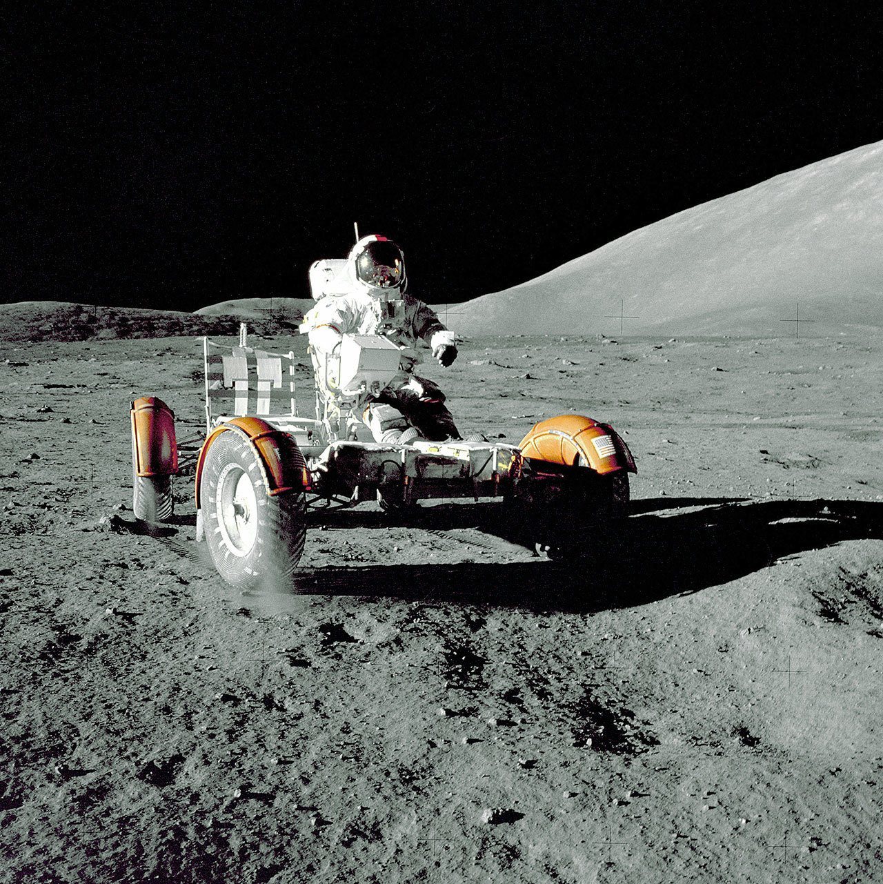 Astronaut Eugene A. Cernan, Apollo 17 mission commander, on the Lunar Roving Vehicle during the Apollo 17 mission at the Taurus-Littrow landing site. This view of the “stripped down” rover is prior to loadup. This photograph was taken by geologist-astronaut Harrison H. Schmitt. (NASA)