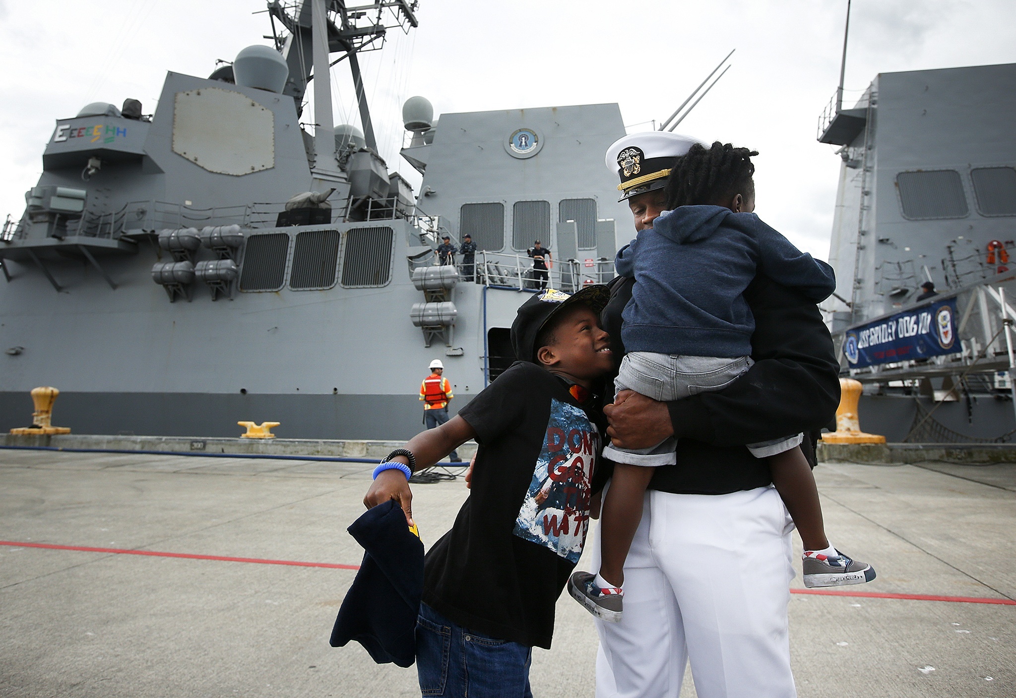 Navy Ensign Joseph Solomon is greeted by his kids Josiya 3, and Joseph, 10, after disembarking from the USS Gridley destroyer ship after her arrival to Naval Station Everett on Saturday. Previously home-ported in San Diego, the USS Gridley will now call Everett home. (Ian Terry / The Herald)
