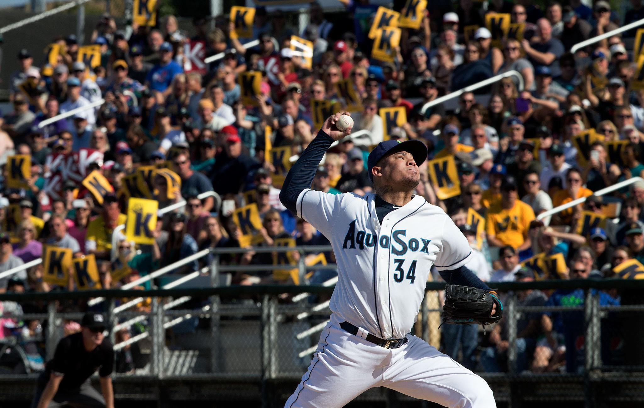 Fans hold up “K” signs as Seattle Mariner’s Felix Hernandez pitches for the Everett AquaSox on Sundauy at Everett Memorial Stadium. (Andy Bronson / The Herald )