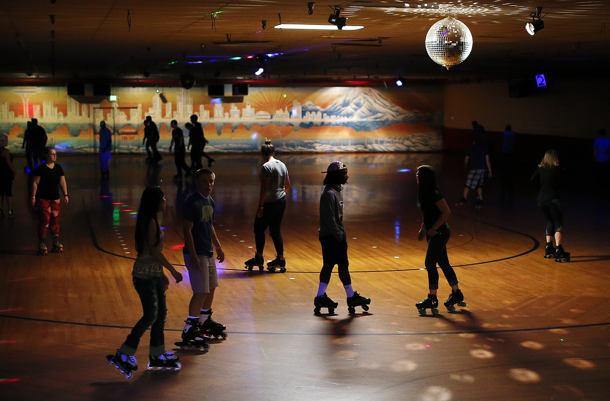 Skaters roll across the floor during a public session at Lynnwood Bowl and Skate on Thursday. The roller skating rink located on Highway 99 in Lynnwood will celebrate its 60th anniversary July 16. (Ian Terry / The Herald)
