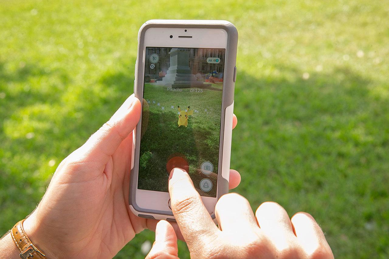 Sarah Boutwell plays the augmented-reality smartphone game Pokémon Go at the Capitol in Austin, Texas, Monday. (Jay Janner/Austin American-Statesman via AP)