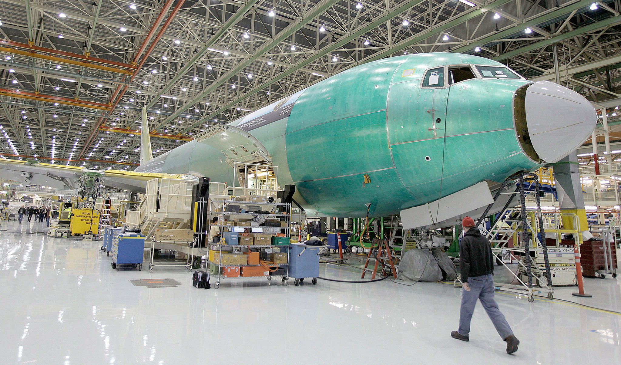 A Boeing Co. employee walks past a Boeing 767 under assembly in February 2011. (Ted Warren / Associated Press)