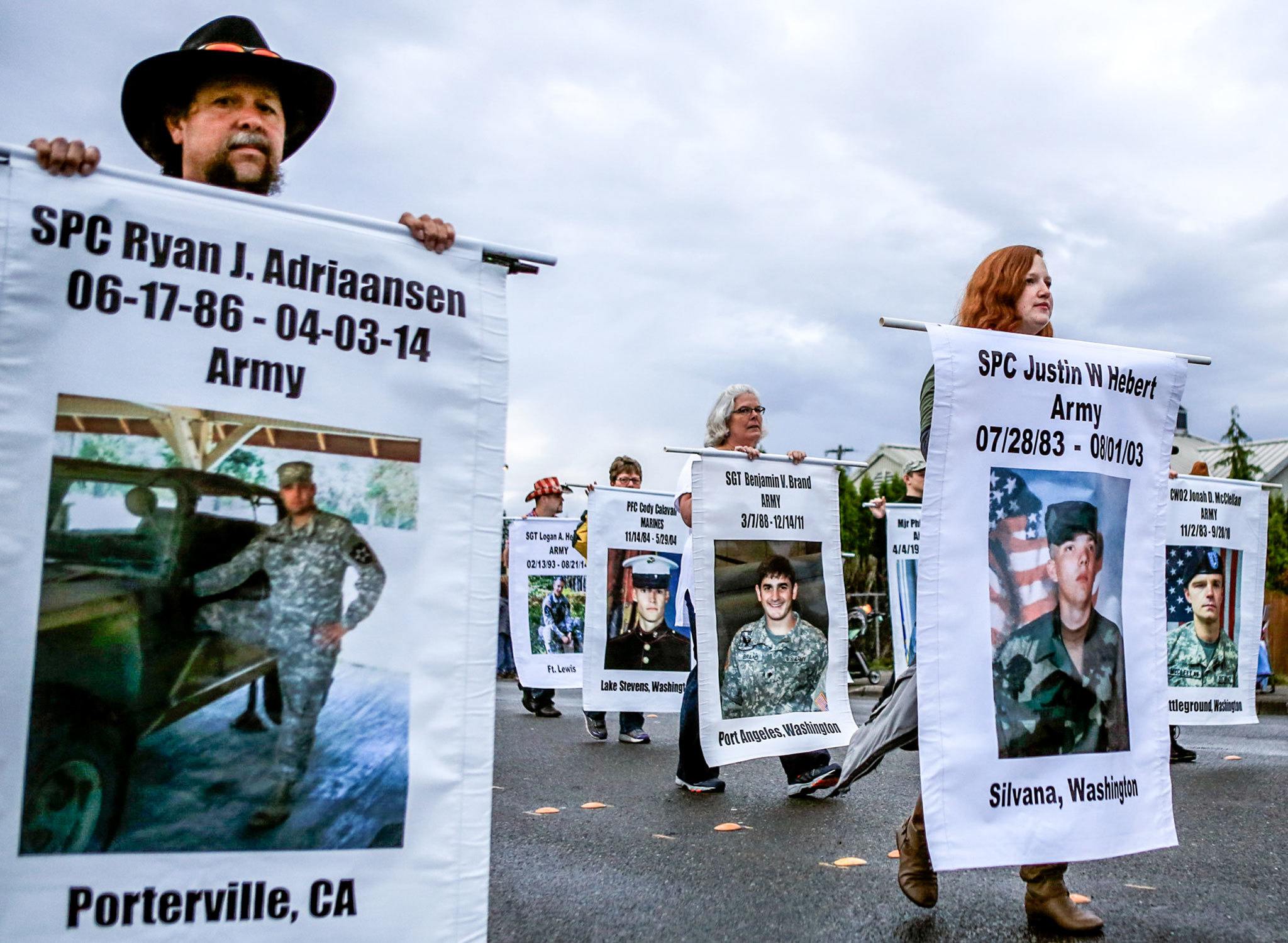 Anthony Trujillo (left), Jessica Hebert (far right) and others march in memory of fallen soldiers during the annual Strawberry Festival Parade in Marysville on June 18. (Kevin Clark / The Herald)