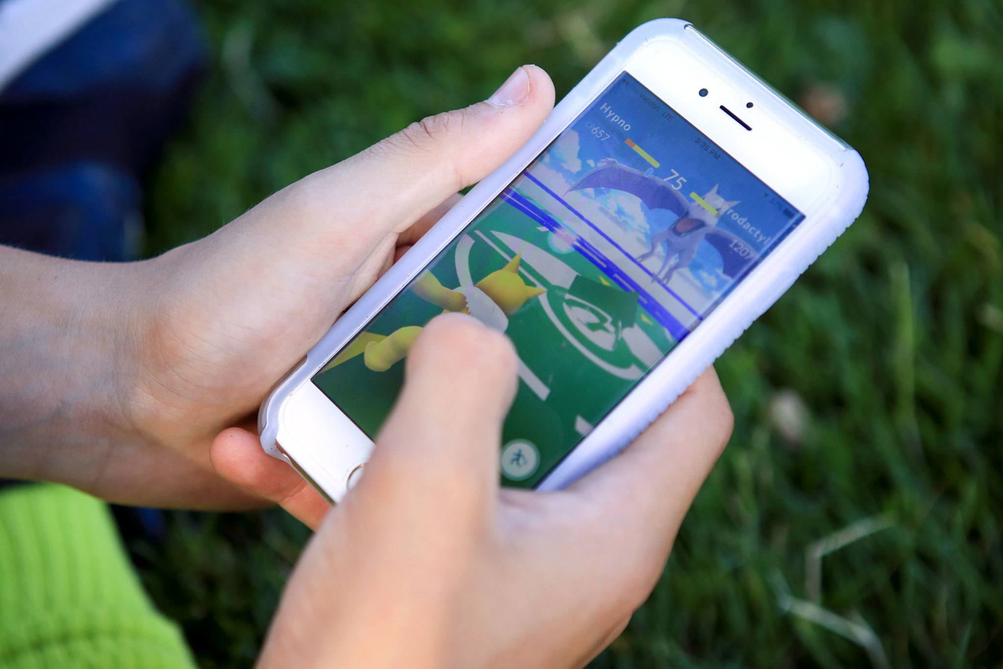 A teen battles in Pokemon Go at Grand Avenue Park in Everett on July 14, 2016. He was far from alone playing the augmented reality smartphone app game during the weekday afternoon. (Kevin Clark / The Herald)