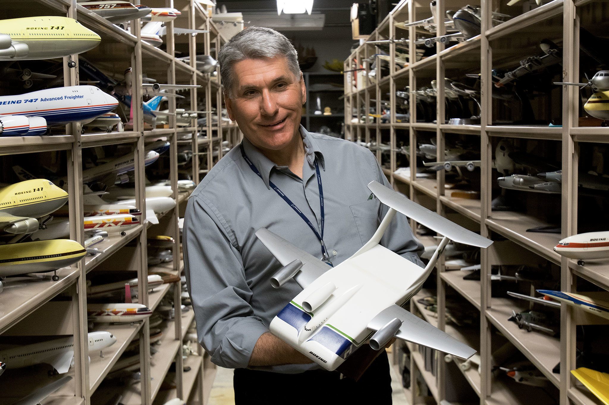 Standing between rows and rows of Boeing models, Michael Lombardi, Director of Boeing Archives at Boeing Corporate Archives, holds a model of the Boeing Model 754 “Husky” Concept plane circa 1974 on Tuesday, April 12, 2016 in Bellevue, Wa. ( Andy Bronson / The Herald )