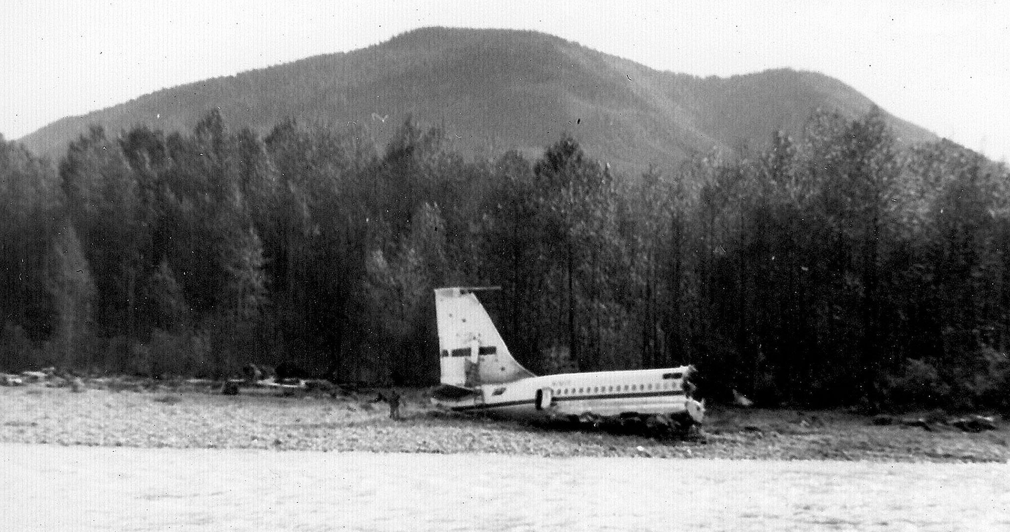 The tail section of a Boeing 707 sits on a sandbar in the North Fork Stillaguamish River on Oct. 19, 1959, after the plane crashed and broke apart. Four of eight people on the plane were killed. (Ron Palmer)