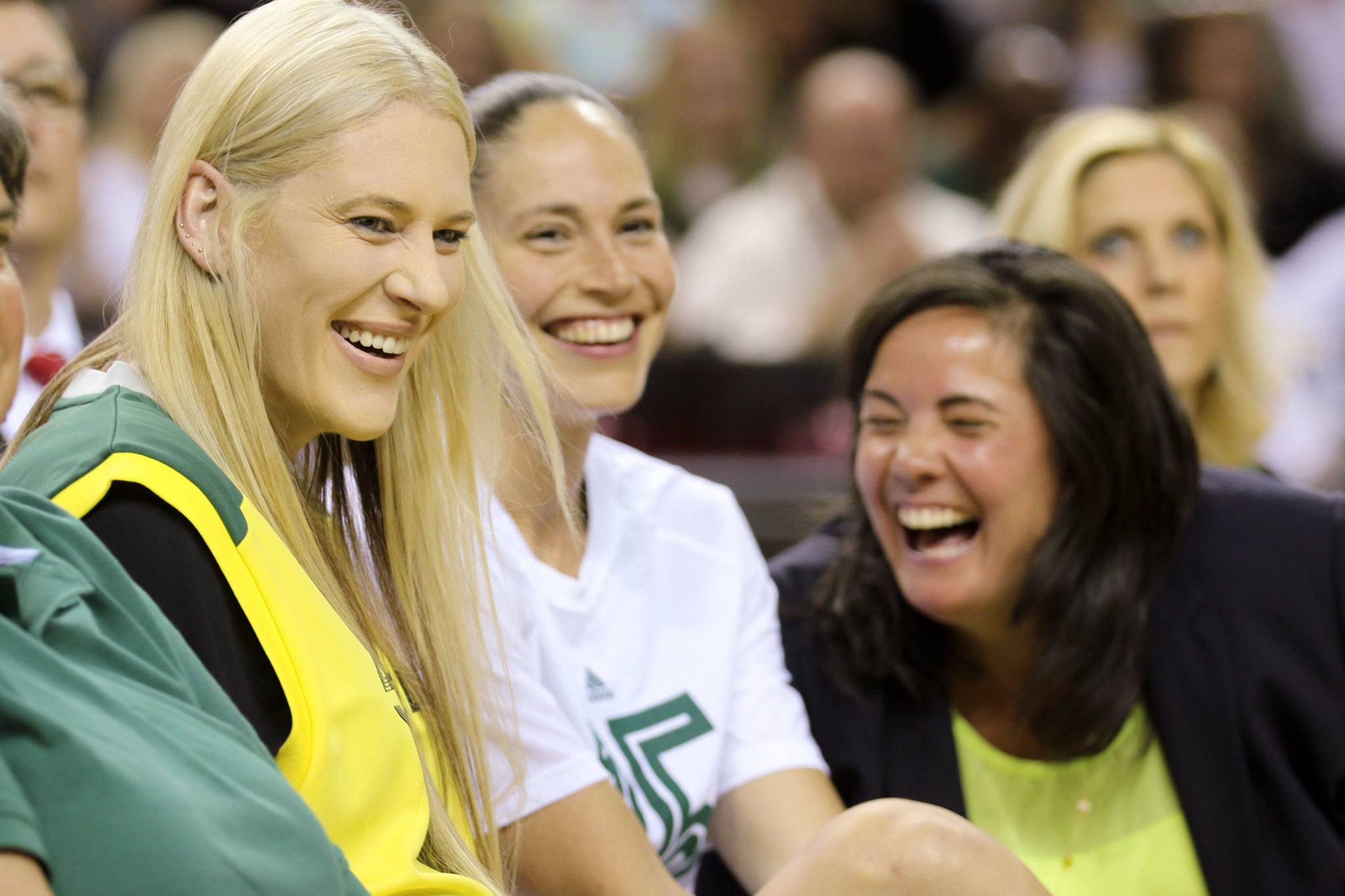 Lauren Jackson (left), Sue Bird (middle) and former Storm team president and Woodway High School alum Karen Bryant share a laugh during a jersey retirement ceremony for Jackson on Friday night in Seattle. (Kevin Clark / The Herald)