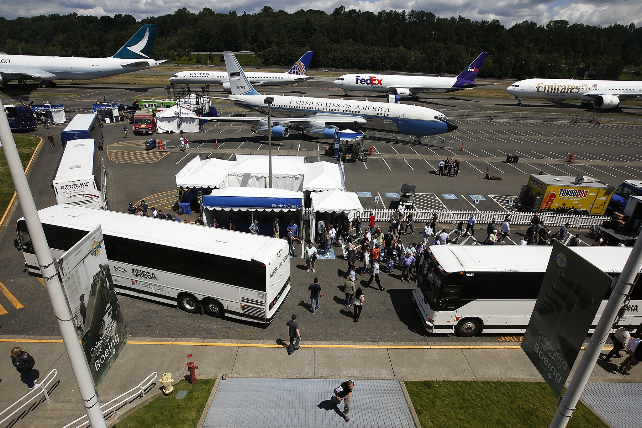 Boeing employees, retirees and family of workers walk around the grounds of Boeing Field in Seattle during the first day of the company’s centennial celebration on Friday. (Ian Terry / The Herald)