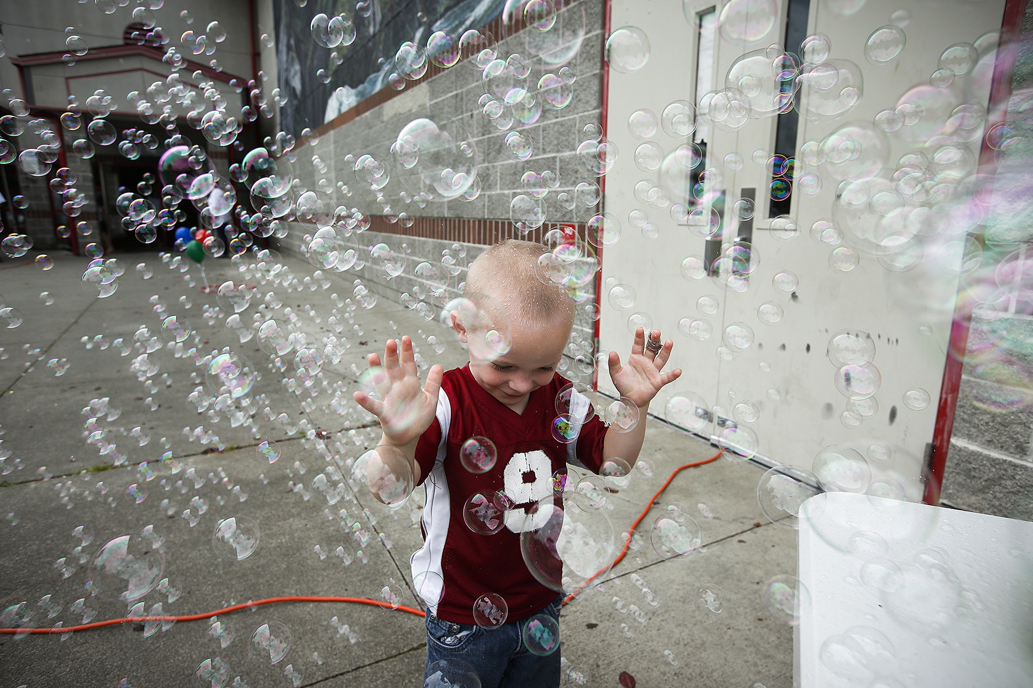 Judah Steele, 4, of Marysville, plays in a stream of bubbles at a family event put on by the new Marysville Community Church on July 9. The church, a plant from the Alderwood Community Church, will open its doors on Sept. 18 in the cafeteria at Cedarcrest Middle School. (Ian Terry / The Herald)