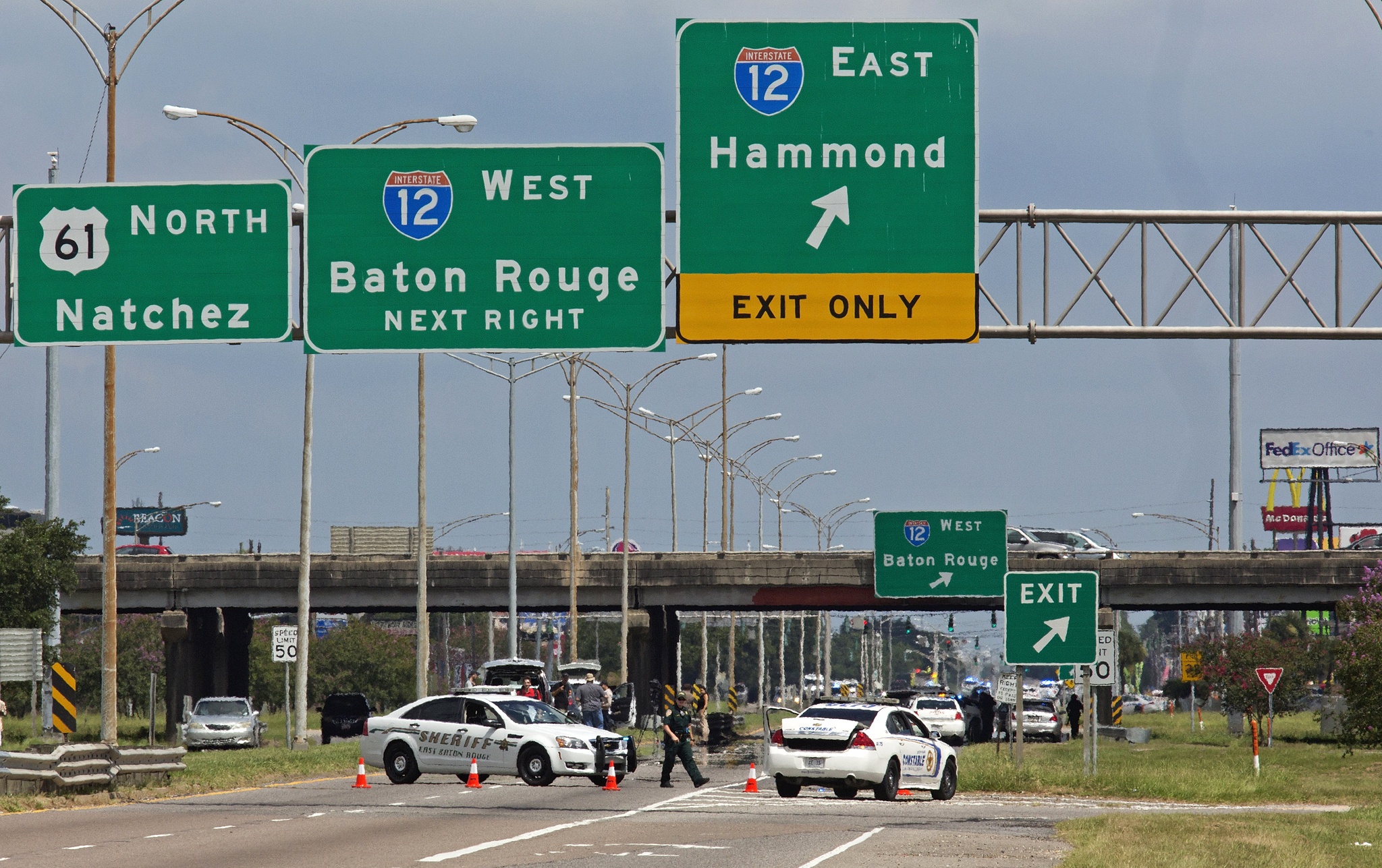 Baton Rouge police block Airline Highway after police were shot in Baton Rouge, Louisiana, on Sunday. Authorities in Louisiana say several law enforcement officers are dead, and several injured. (AP Photo/Max Becherer)