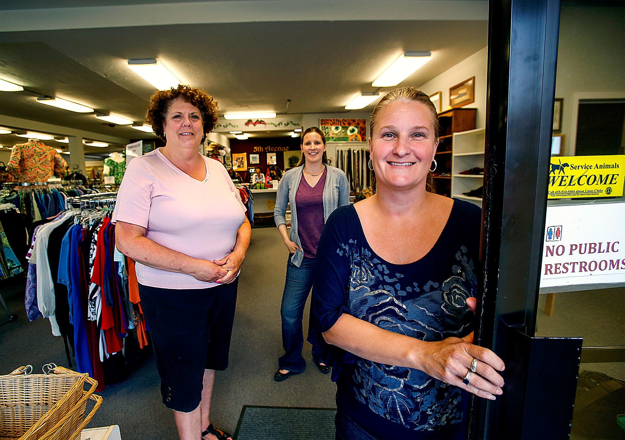 At Everett’s New & Again Thrift Shoppe, Debra Bordsen (from left), Stephanie Civey and Amber McGuire are preparing for the store’s move to a new location. The shop supports Domestic Violence Services of Snohomish County. Bordsen is the nonprofit’s deputy director for development, Civey is events, marketing and volunteer coordinator, and McGuire manages the shop that will reopen Aug. 1 at 3010 Grand Ave. (Dan Bates / The Herald)