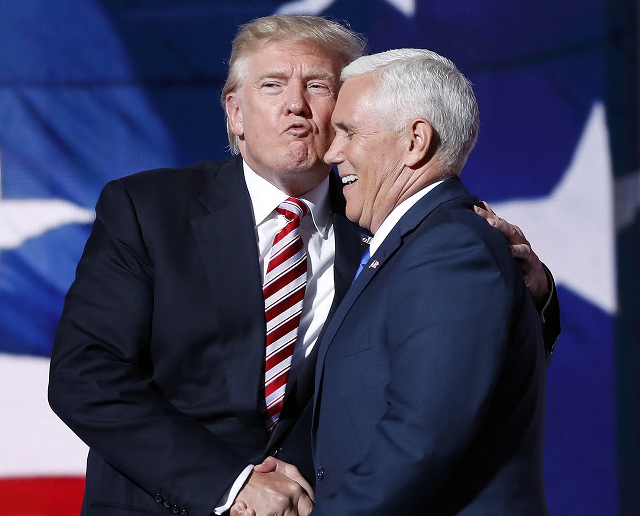 Republican presidential Candidate Donald Trump gives his running mate, Republican vice presidential nominee Gov. Mike Pence of Indiana, a kiss as they shake hands after Pence’s acceptance speech during the third day session of the Republican National Convention in Cleveland on Wednesday. (AP Photo/Mary Altaffer)