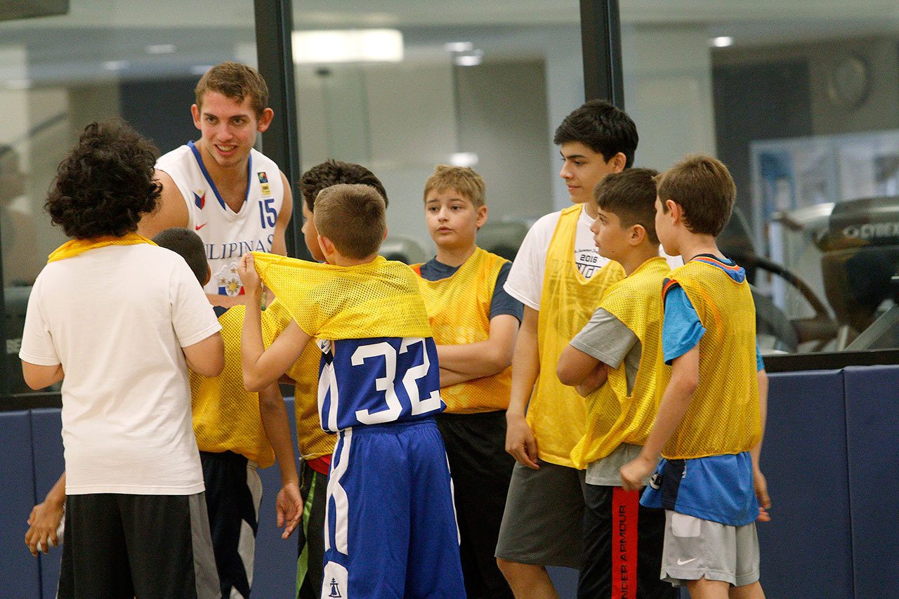 Former Jackson High School basketball standout Jason Todd works with youngsters during a recent youth basketball camp at California Baptist University. Todd will play for Cal Baptist in the upcoming season after transferring from the University of Portland. (California Baptist University photo)