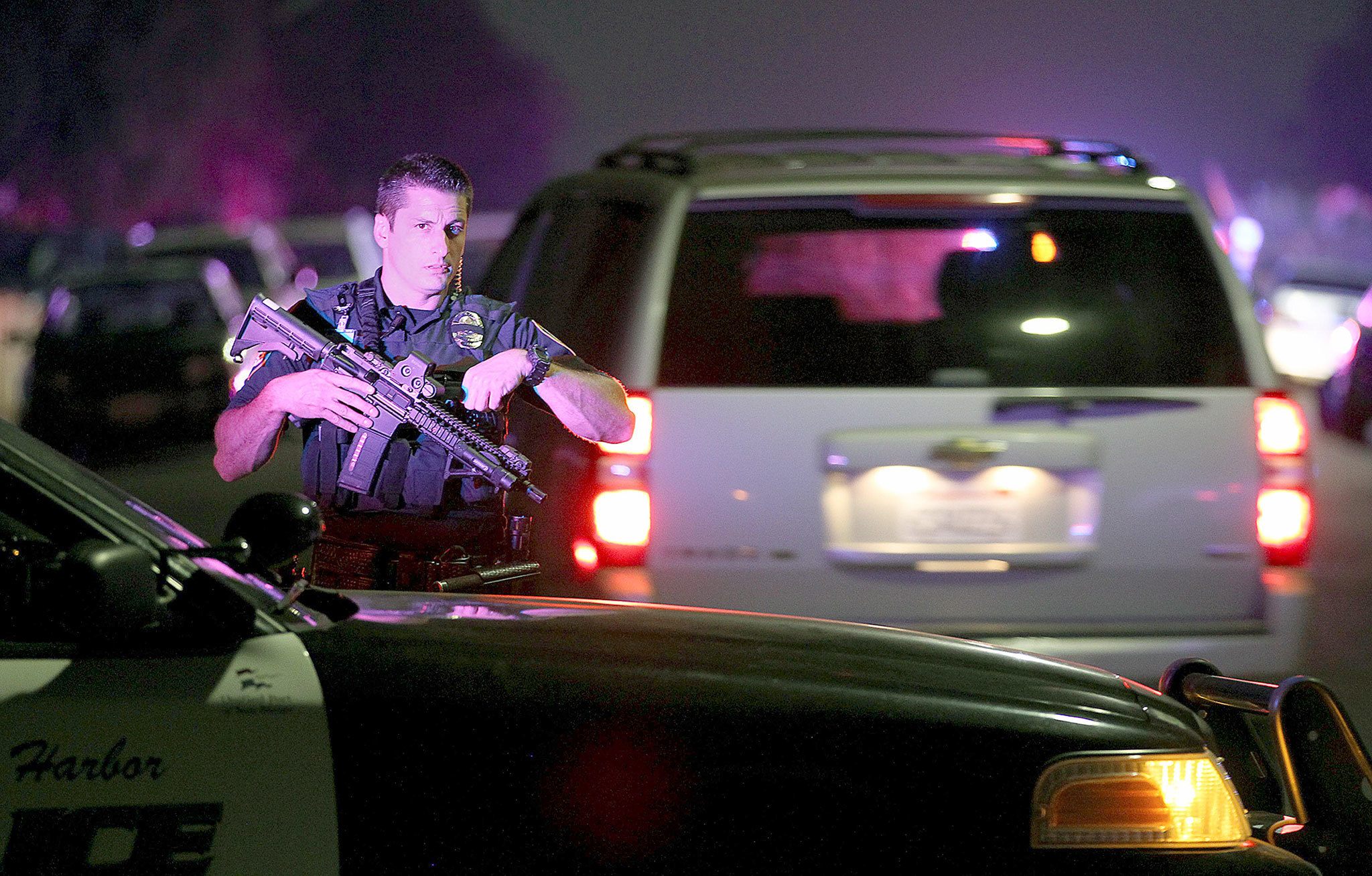 A San Diego Harbor Police officer helps to secure the scene where two San Diego Police officers were shot Thursday night. (John Gastaldo/The San Diego Union-Tribune)