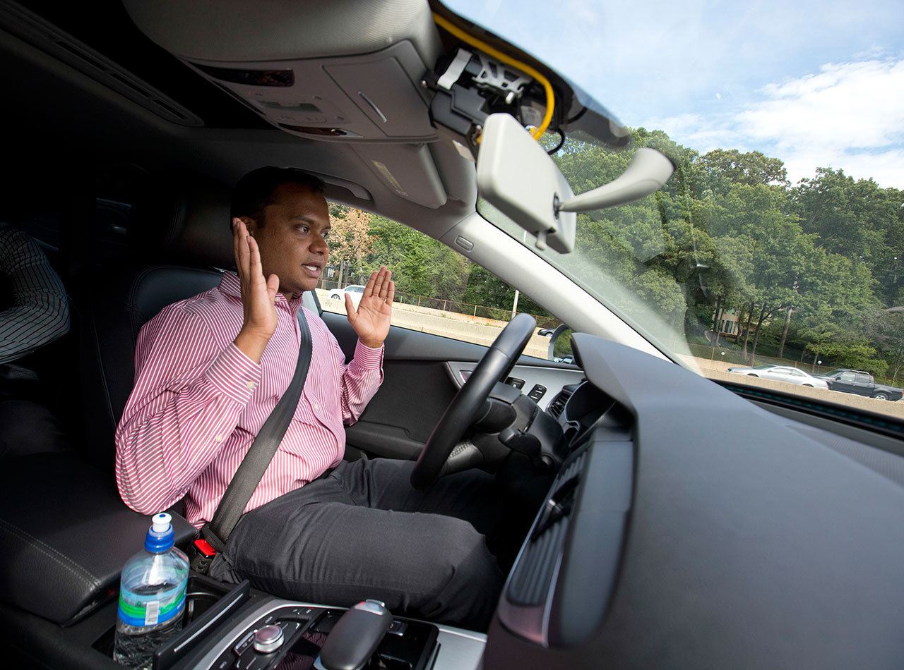 Kaushik Raghu, Senior Staff Engineer at Audi, takes his hands off the steering wheel while demonstrating an Audi self driving vehicle on I-395 expressway in Arlington, Va., Friday, July 15, 2016. (AP Photo/Pablo Martinez Monsivais)