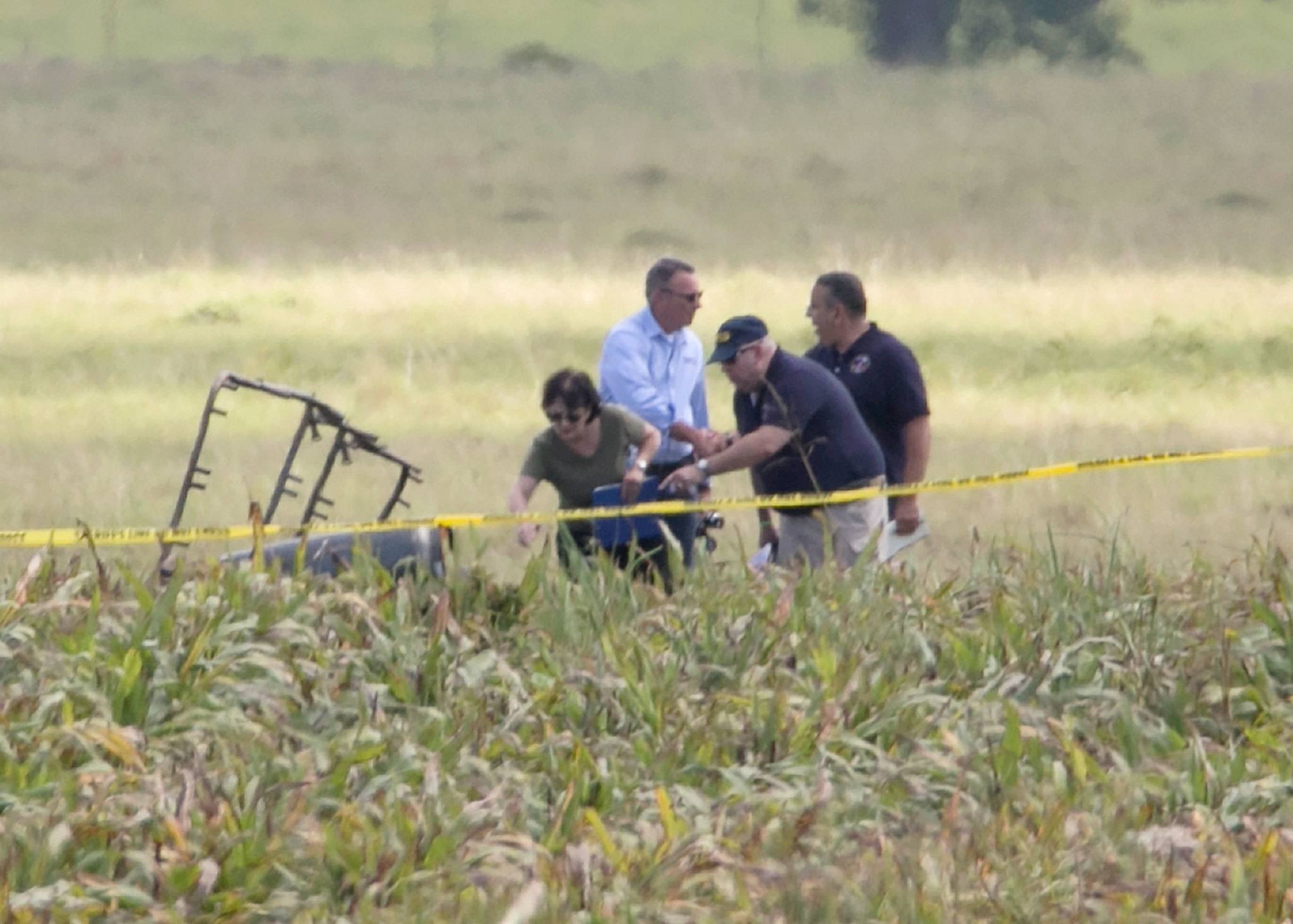 The partial frame of a hot air balloon is visible in a field as investigators comb the wreckage Saturday near Lockhart, Texas. (Ralph Barrera/Austin American-Statesman)