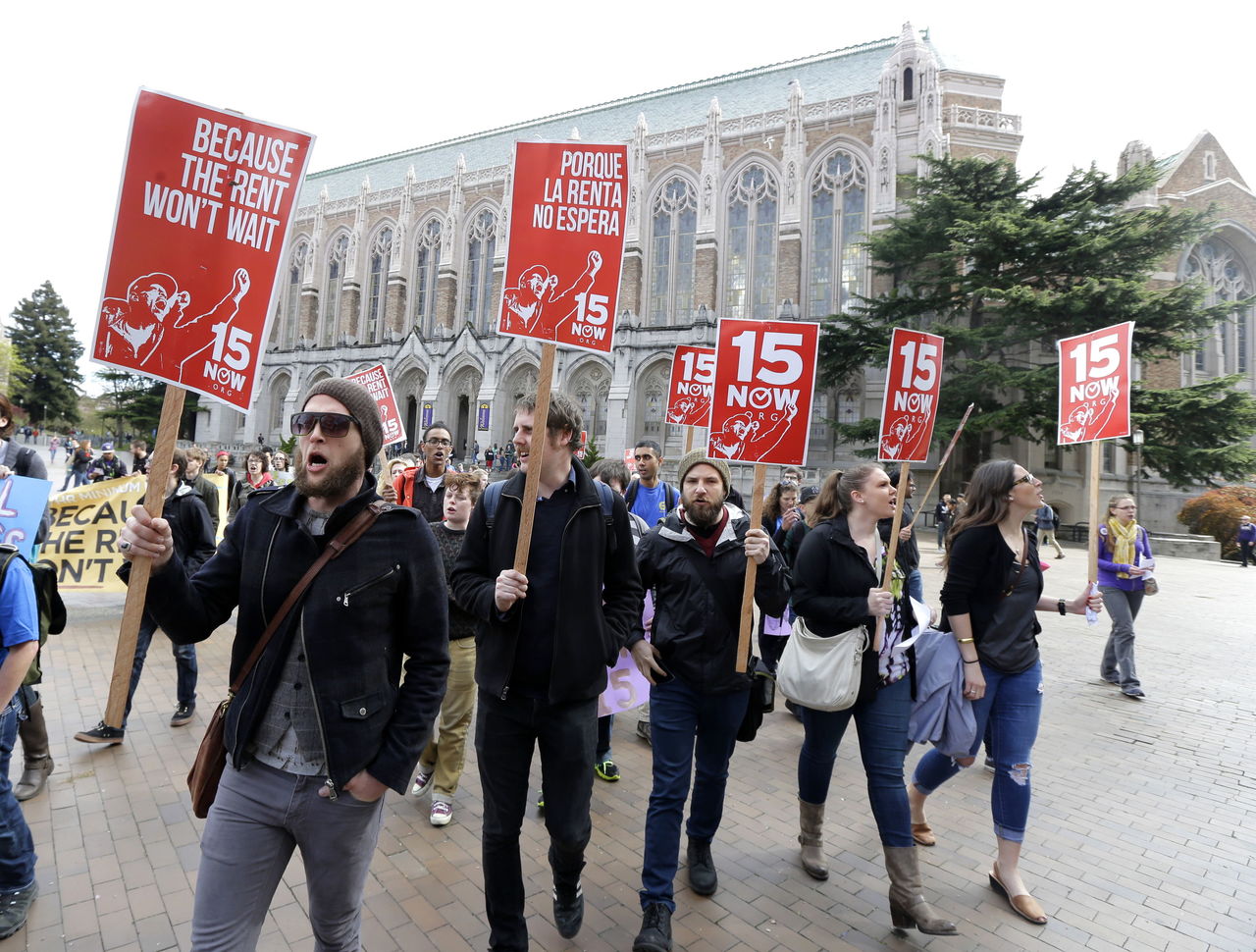 In this April, 1, 2015, photo, students and other supporters protest on the University of Washington campus in Seattle in support of raising the minimum wage for campus workers to $15 an hour.