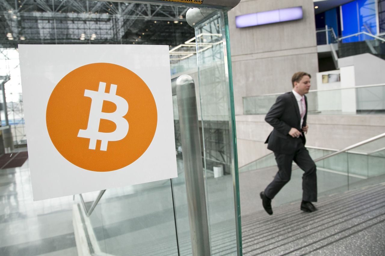 In this April 7 photo, a man arrives for the Inside Bitcoins conference and trade show in New York. An Australian man long thought to be associated with the digital currency Bitcoin has publicly identified himself as its creator.